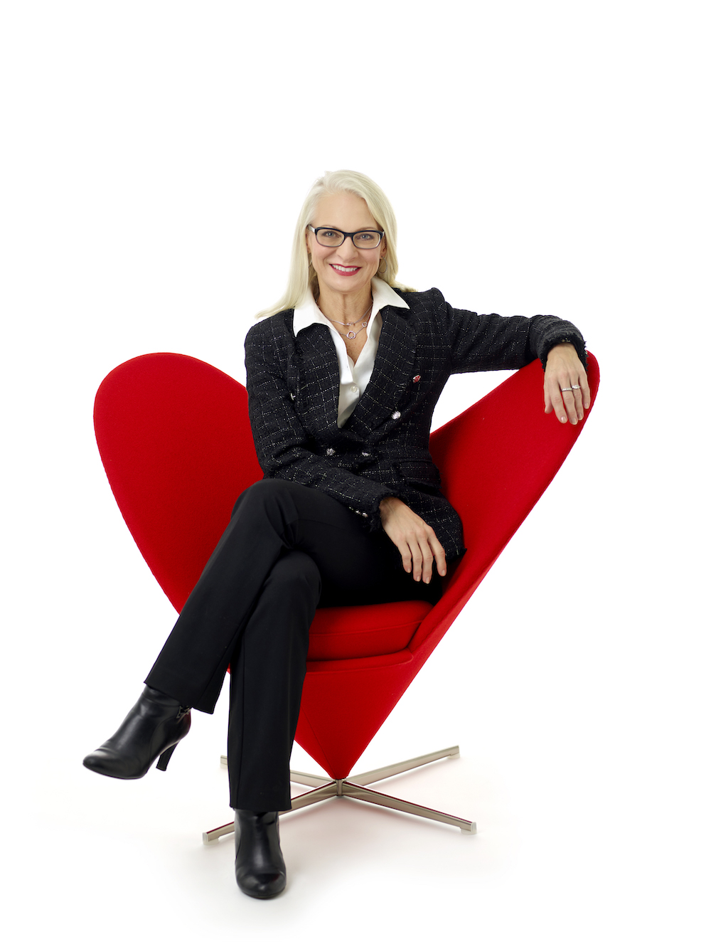 Sharon John sitting in a red chair